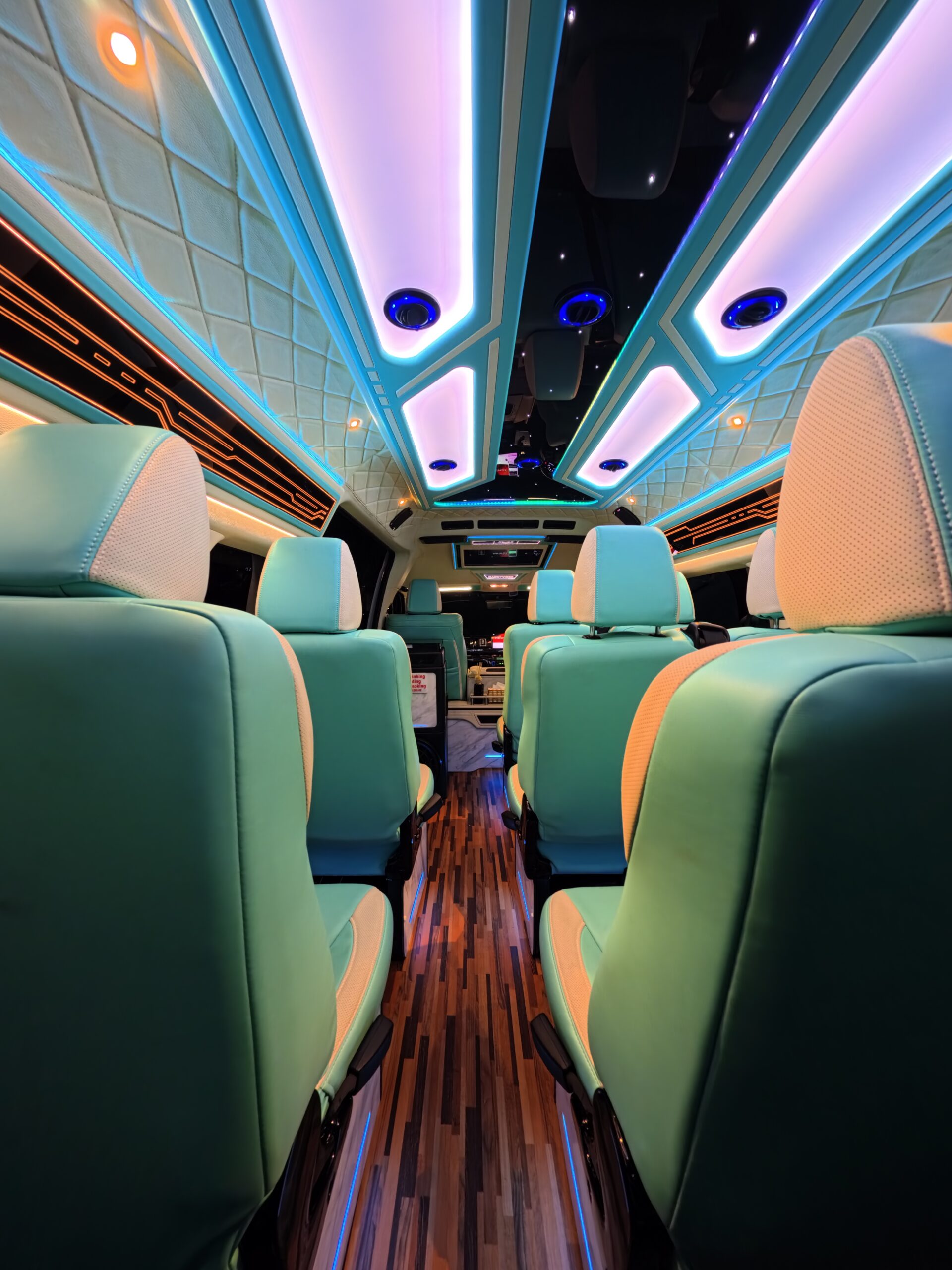 Luxury van interior with premium seating, LED ambient lighting and spacious design for private transport services